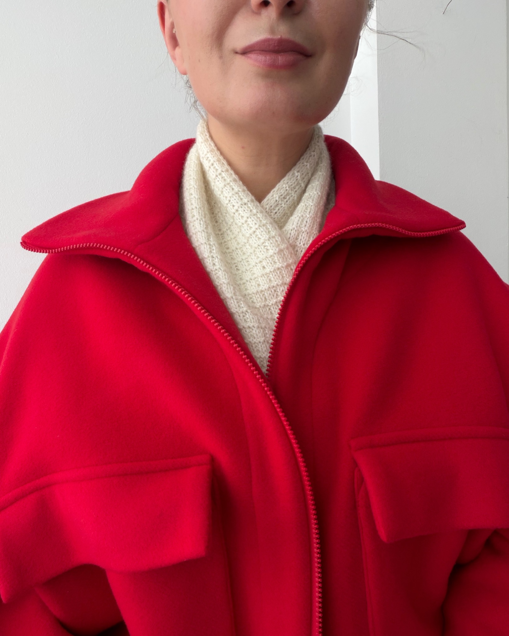 Cream Amelle Scarf styled with a red coat