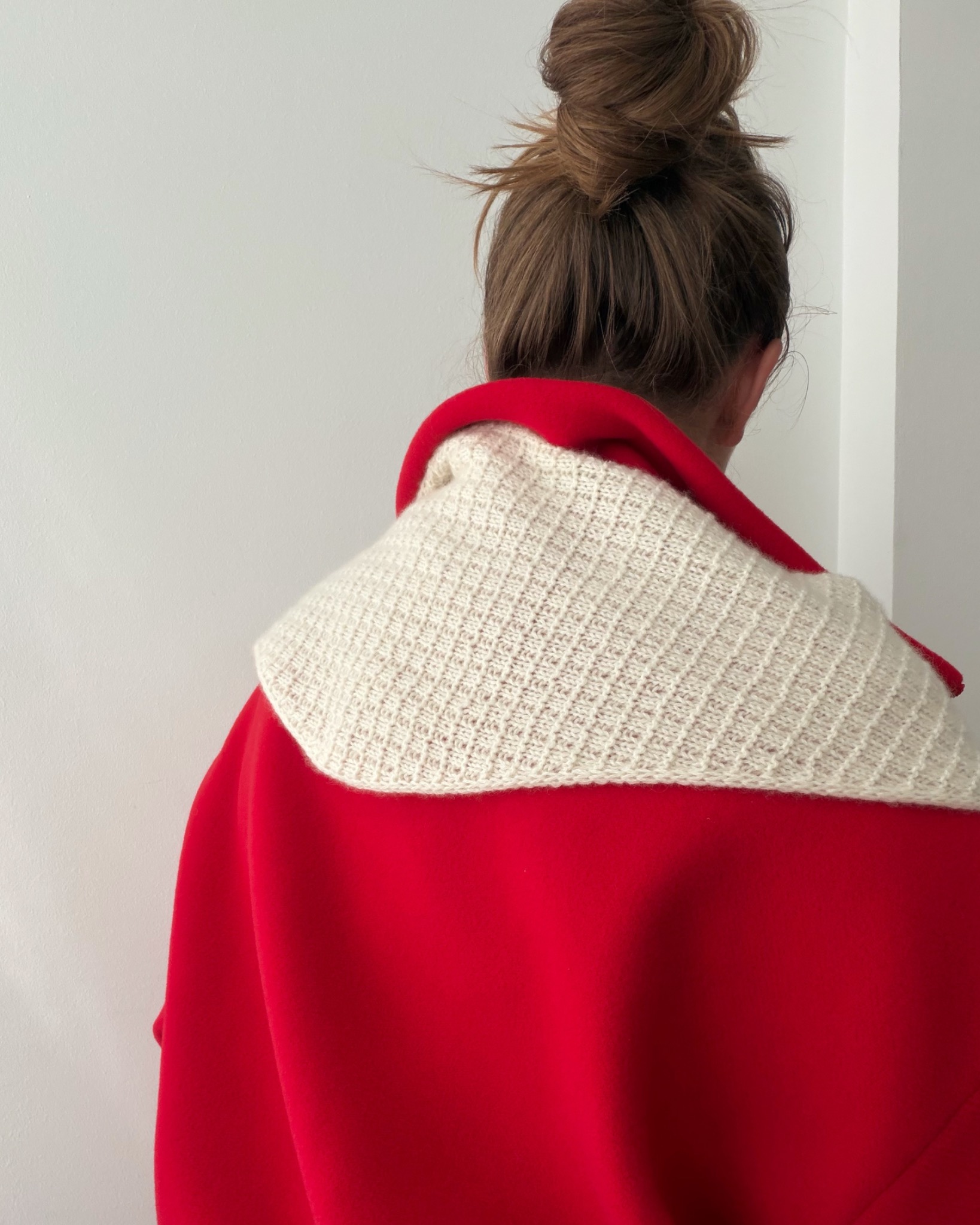 Amelle Scarf from the back with a red coat